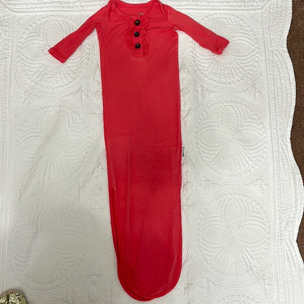 Newborn GiGi and Max tie gown. Color is coral.